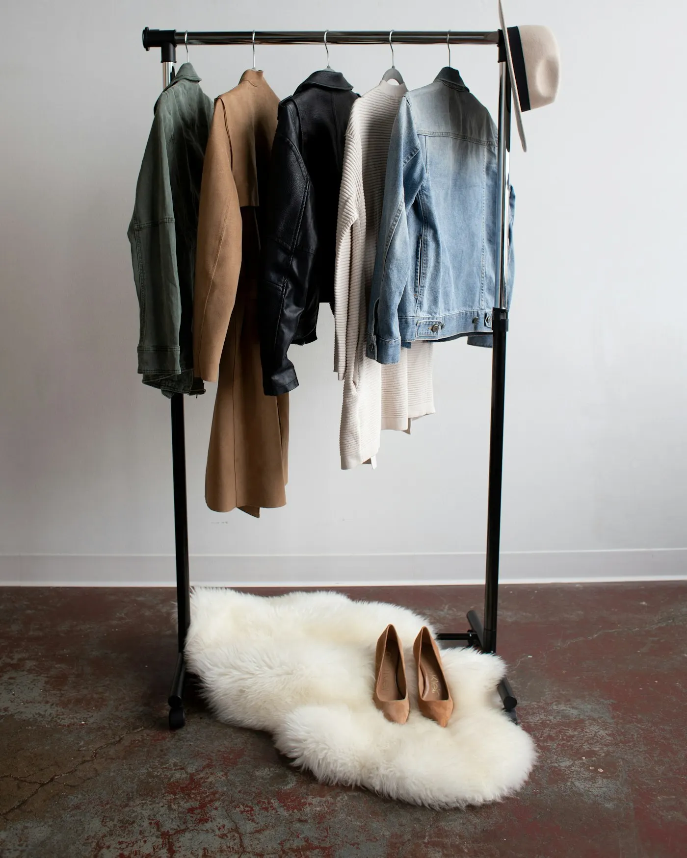 A rack of jackets and coats in neutral tones